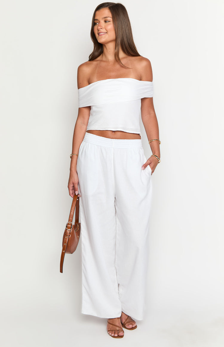 Front view of white linen blend pants with an elasticated waistband and functional side pockets