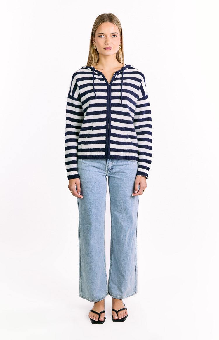 Front view of a navy and white striped knit zip sweater with a hood, long sleeves, and front pockets