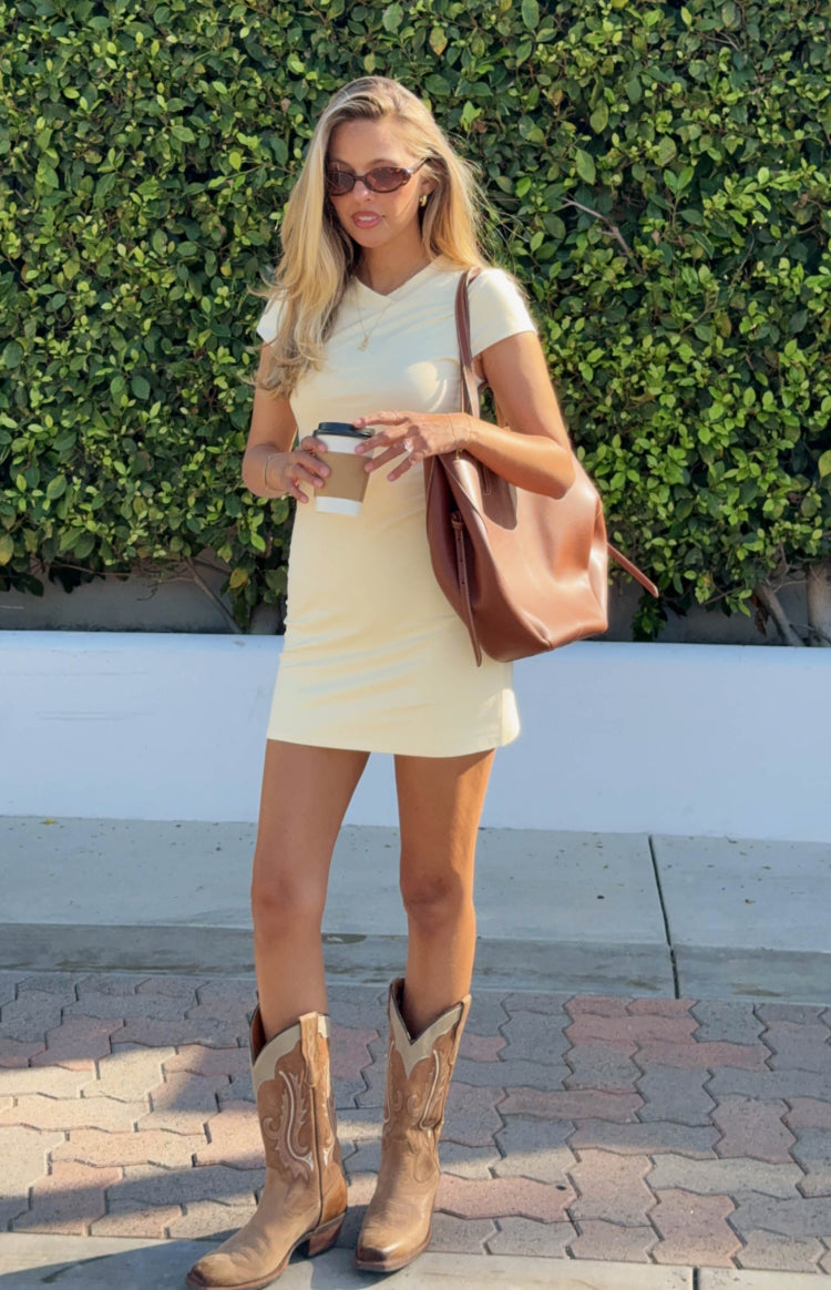 Full view of a fitted yellow jersey mini dress with a V-neckline and short sleeves