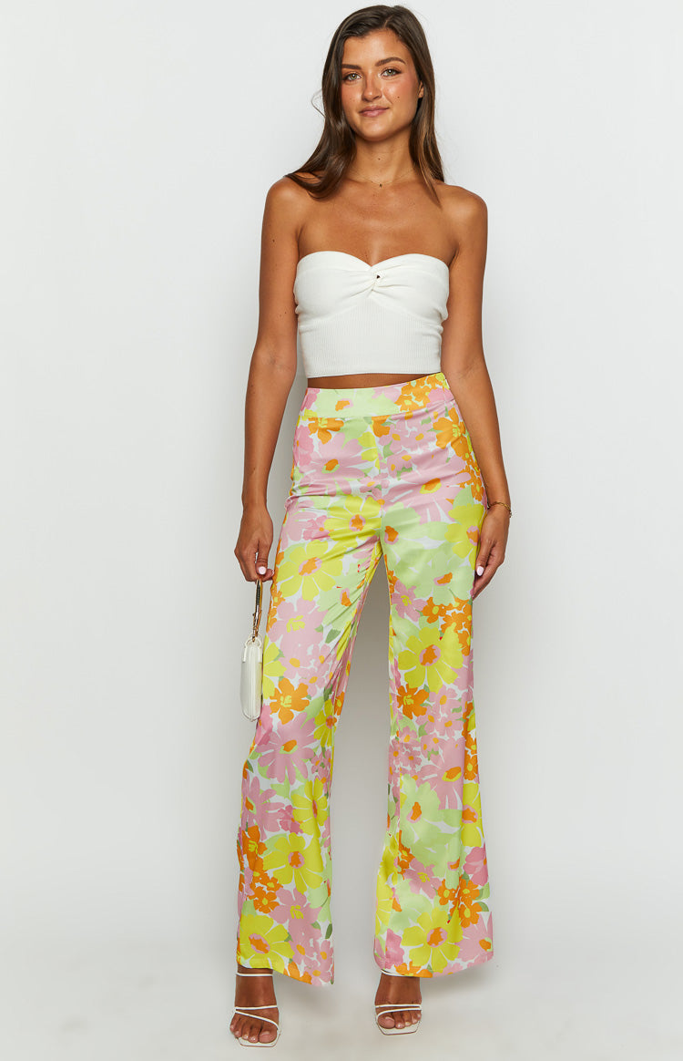 Flowy yellow, pink, and orange floral wide-leg pants with a high waist and relaxed fit