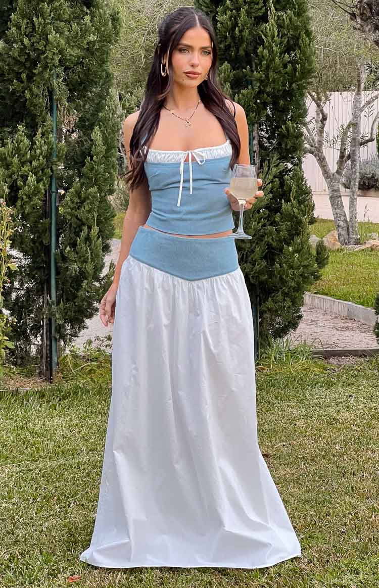 White maxi skirt with a light blue V-shaped waistband and a flowy silhouette