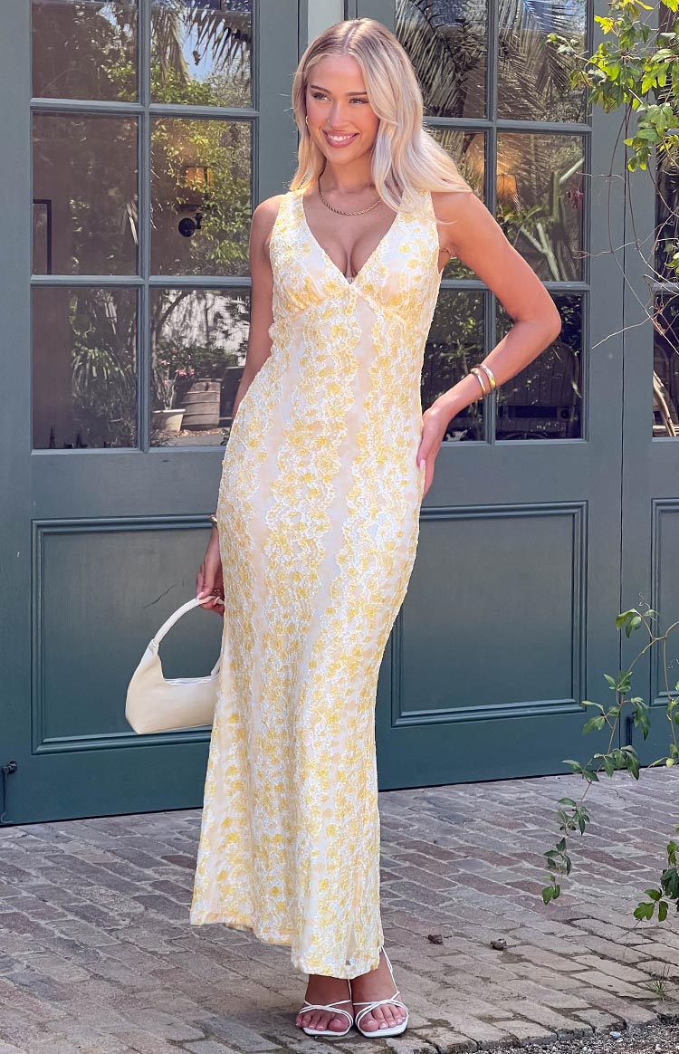 Front view of a yellow lace maxi dress with a V-neckline and fitted silhouette