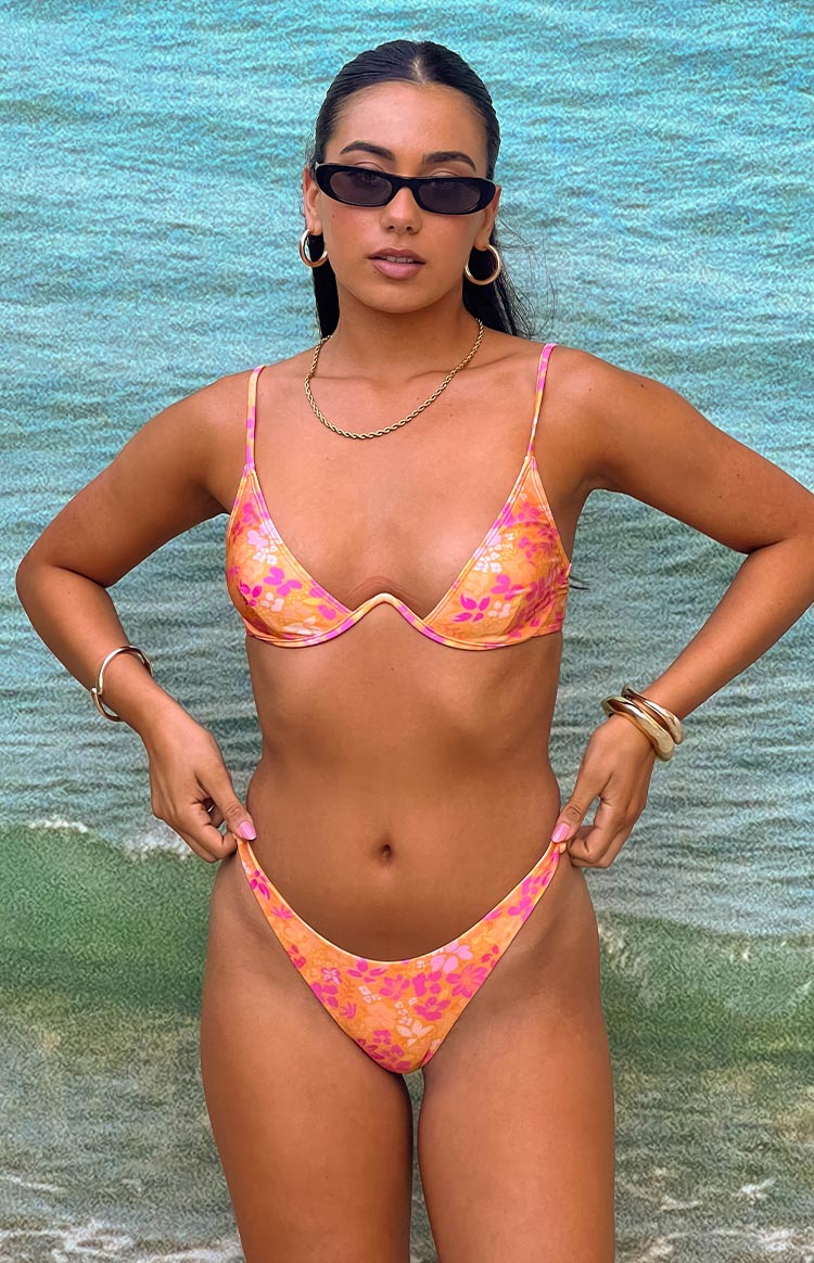 Front view of orange and pink floral high-cut bikini bottoms with a V-shaped front