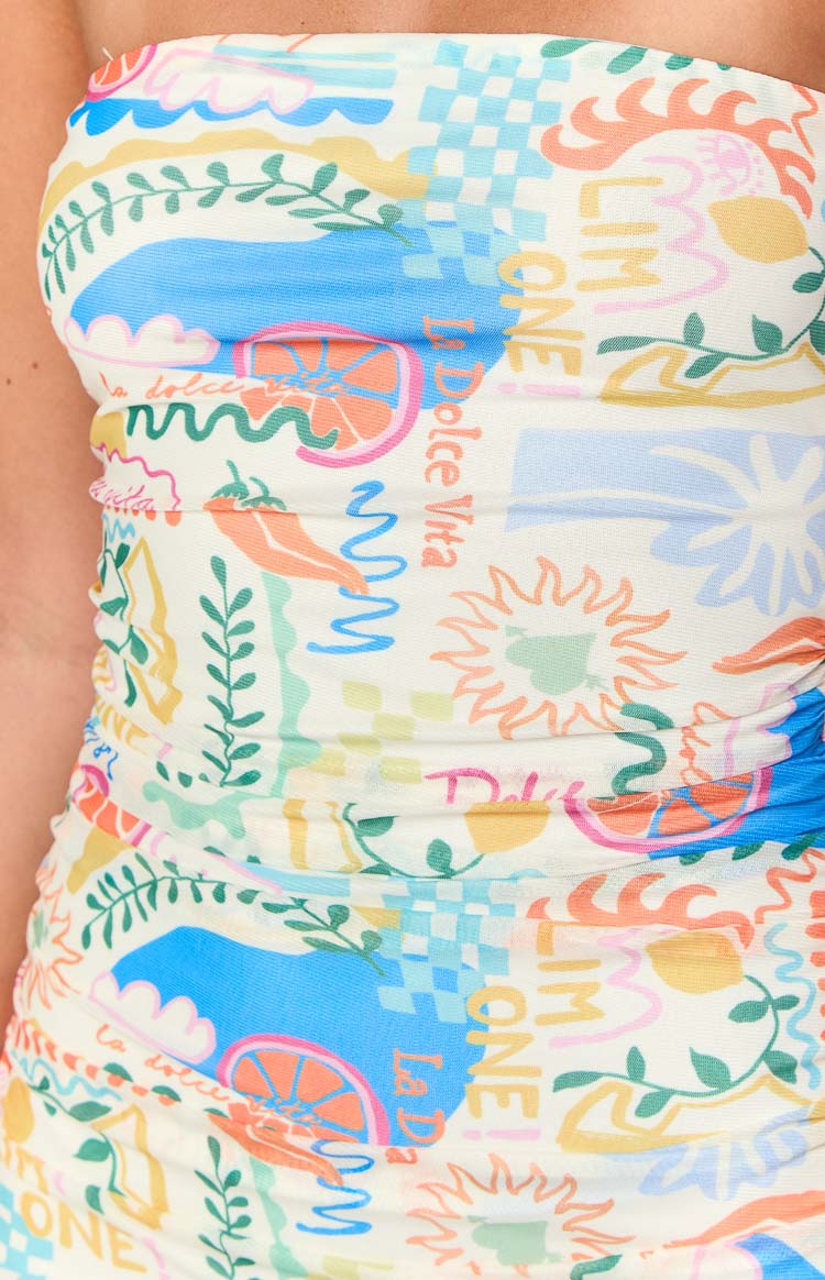 Close-up of the off-white Dolce print gathered mini dress, showing citrus, sun, and 'La Dolce Vita' text