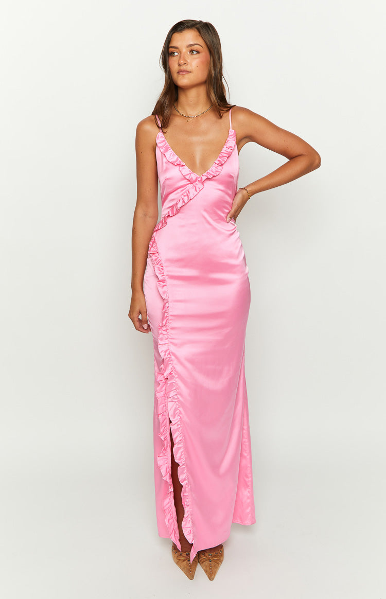 Front view of a pink satin maxi dress with a ruffled V-neckline and a high side slit created by cascading ruffles