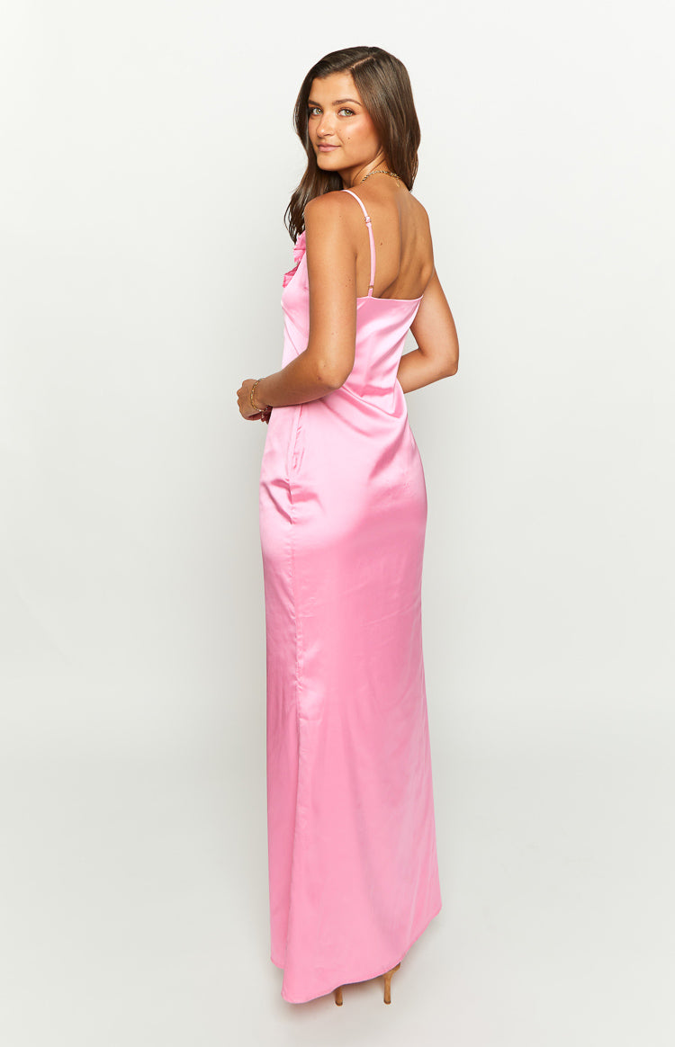 Side view of a pink satin maxi dress showing spaghetti straps, a fitted silhouette, and bust ruffle detail