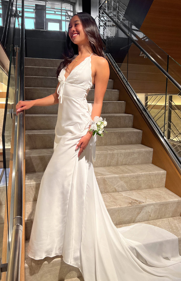 Beginning Boutique Nicole White Maxi Dress white satin deep V-neck halter tie-front ruched side maxi dress with flowy skirt and train