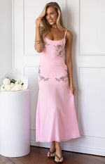Light pink midi dress with thin spaghetti straps, brown floral embroidery on the bodice, and a flowy skirt