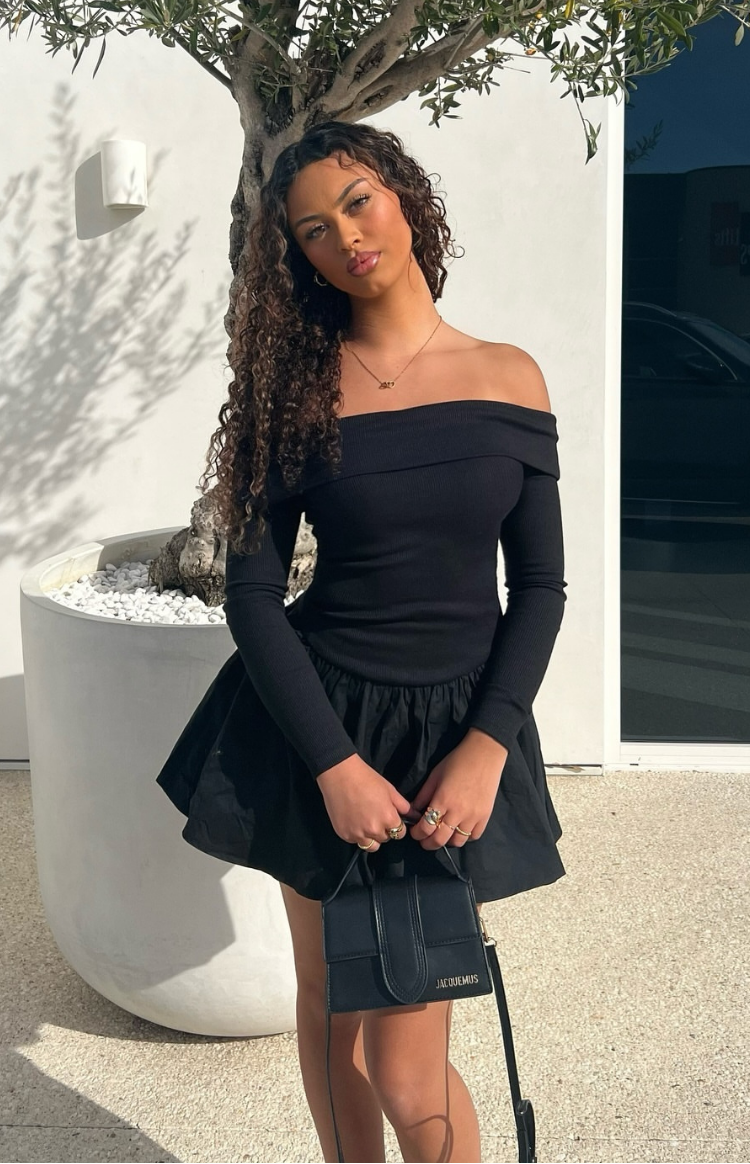 Black off-shoulder ribbed long sleeve mini dress with a voluminous gathered skirt
