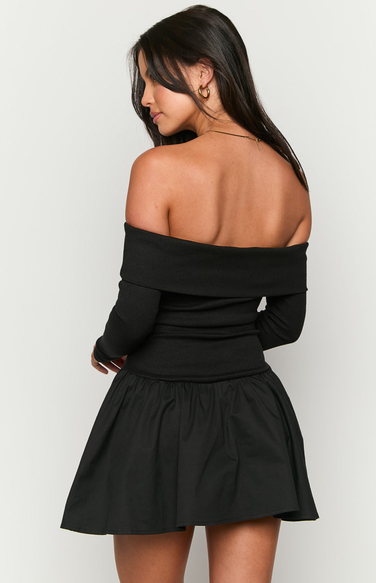 Rear view of a black off-shoulder ribbed knit mini dress with long sleeves and a gathered skirt