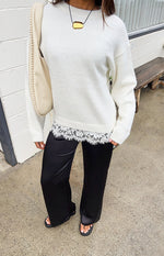 Full length black satin straight leg pants with a relaxed fit and subtle sheen