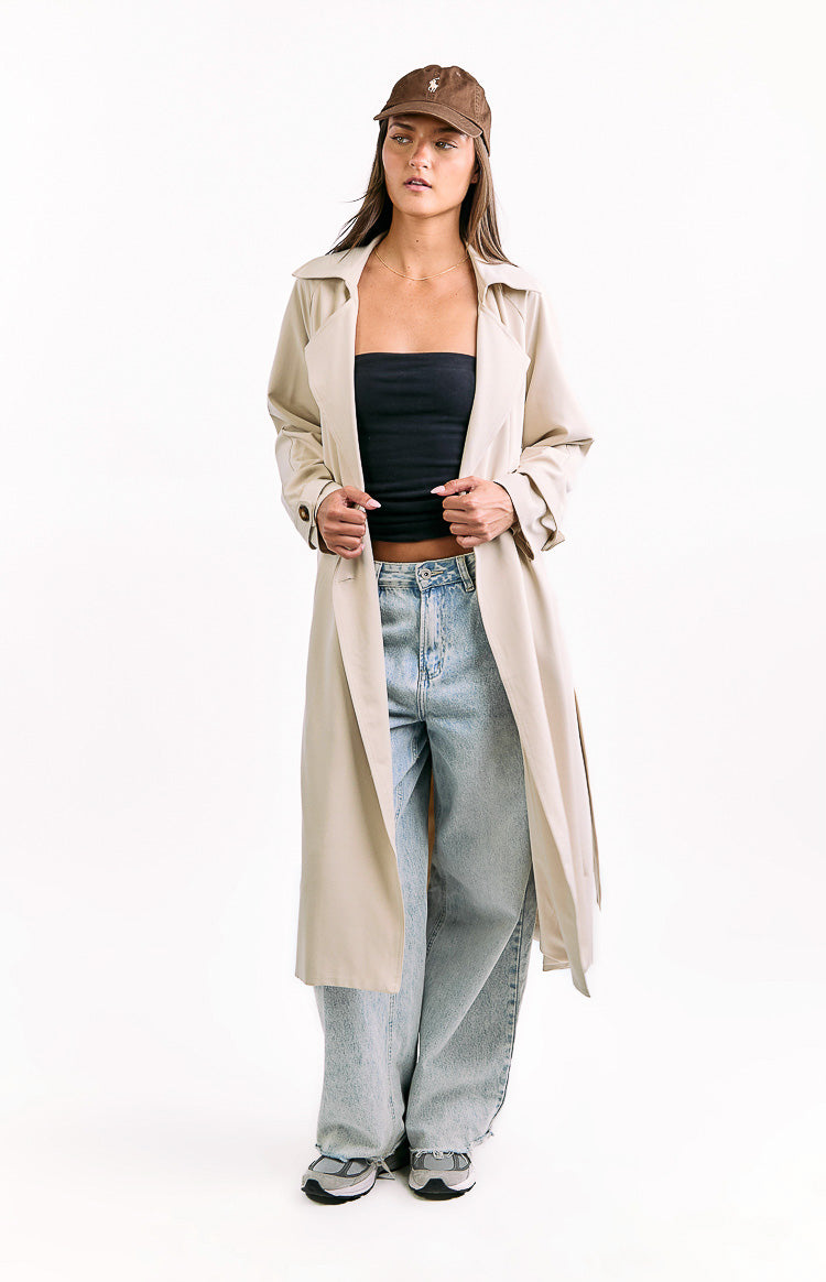 Cream longline trench coat worn open, showcasing its relaxed fit and smooth fabric