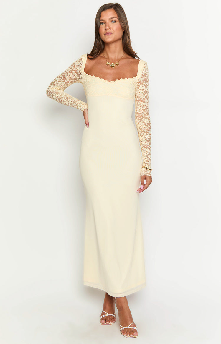 Cream maxi dress with a square neckline, scalloped lace trim, and long floral lace sleeves