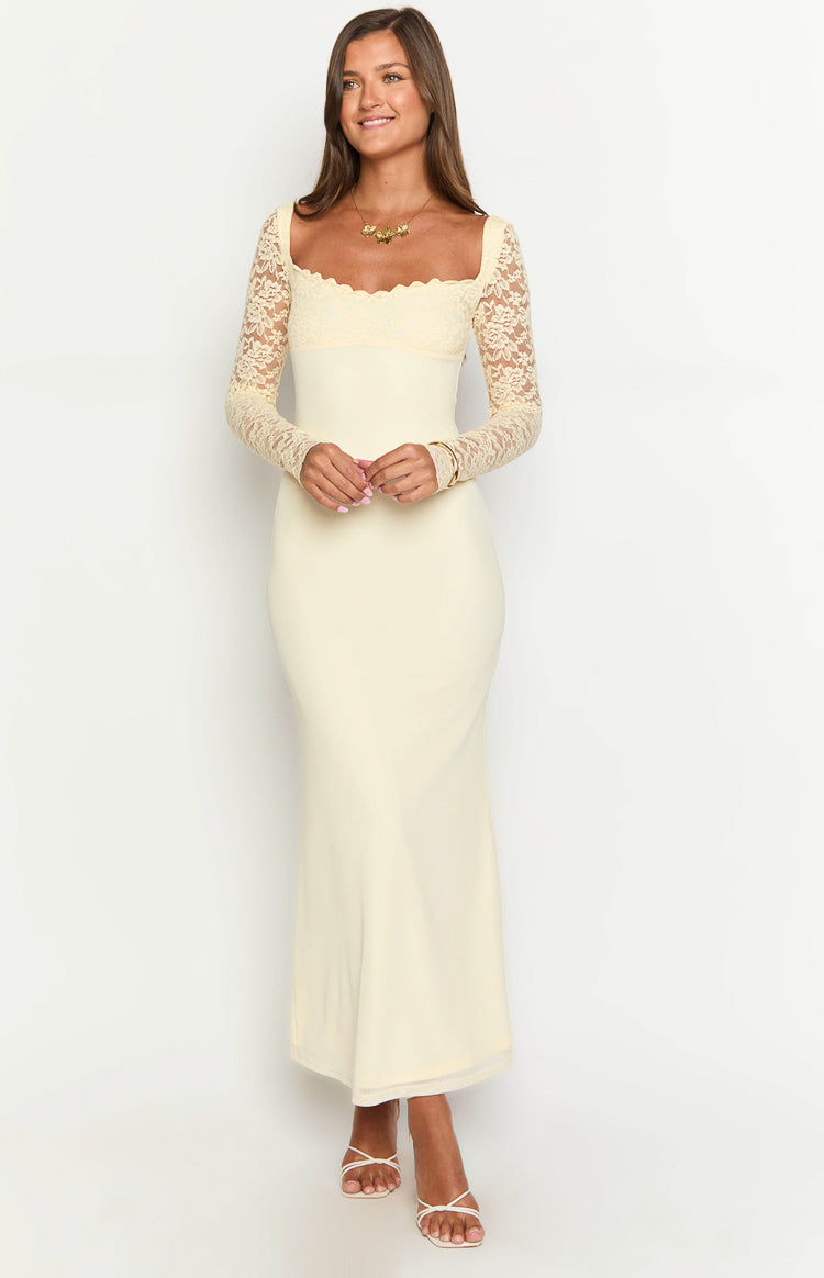 Cream maxi dress with a square neckline, scalloped lace trim, long lace sleeves, and a fitted silhouette