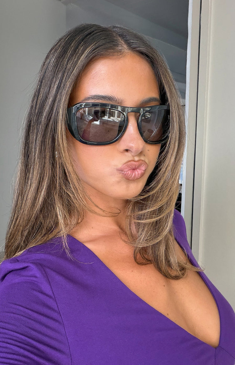 Black oversized rectangular sunglasses with dark reflective lenses