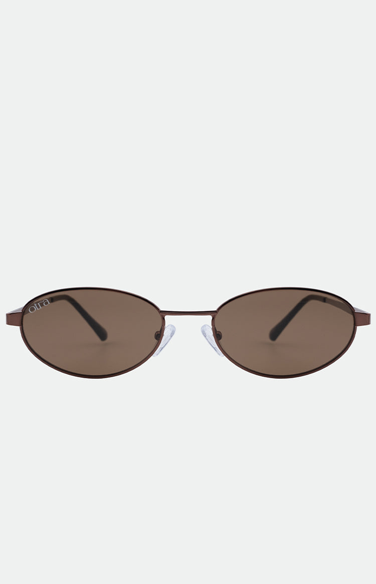 Brown oval sunglasses with thin metal frames, dark tinted lenses, and clear nose pads