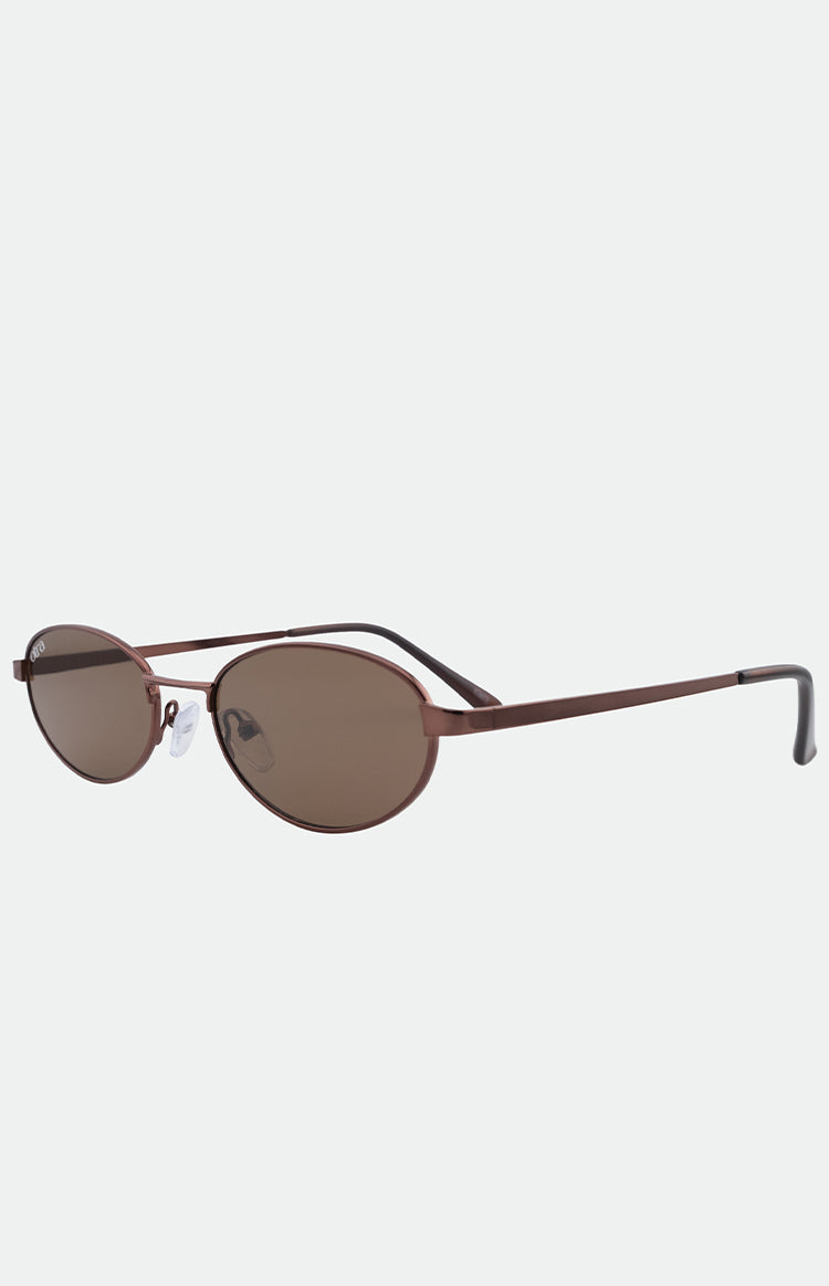 Angled view of brown oval sunglasses with thin metal frames and brown tinted lenses