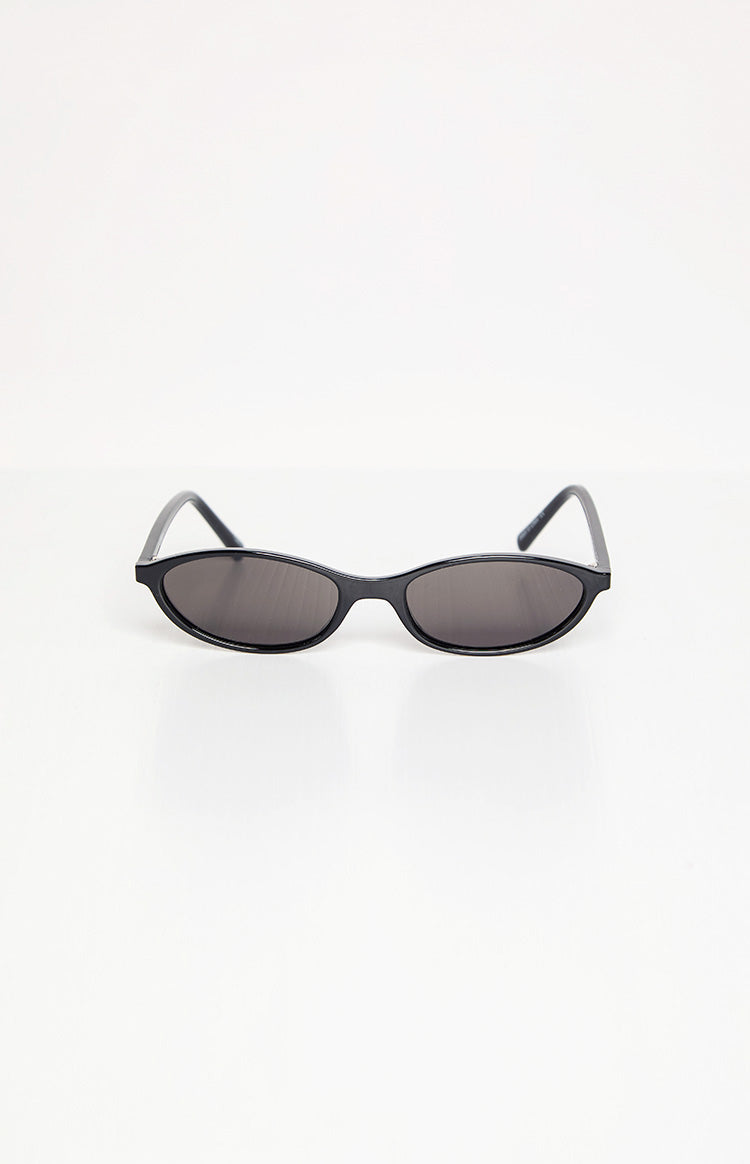 Slightly elevated front view of black cateye sunglasses with slim frames and dark tinted lenses
