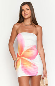 White strapless mini dress with a large pink and yellow frangipani flower print