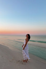 Side view of a white floral print maxi skirt with multiple tiers of gathered ruffles