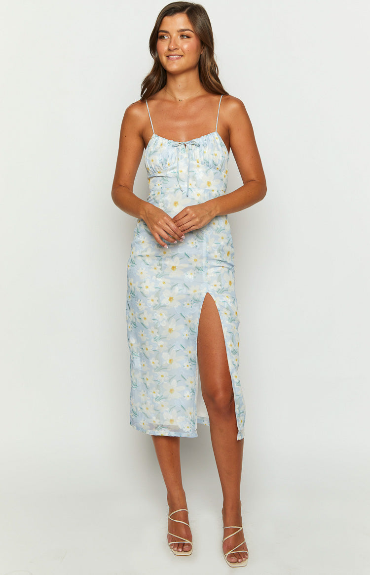 Front view of a light blue floral midi dress with a high left leg slit and tie-front ruched bust