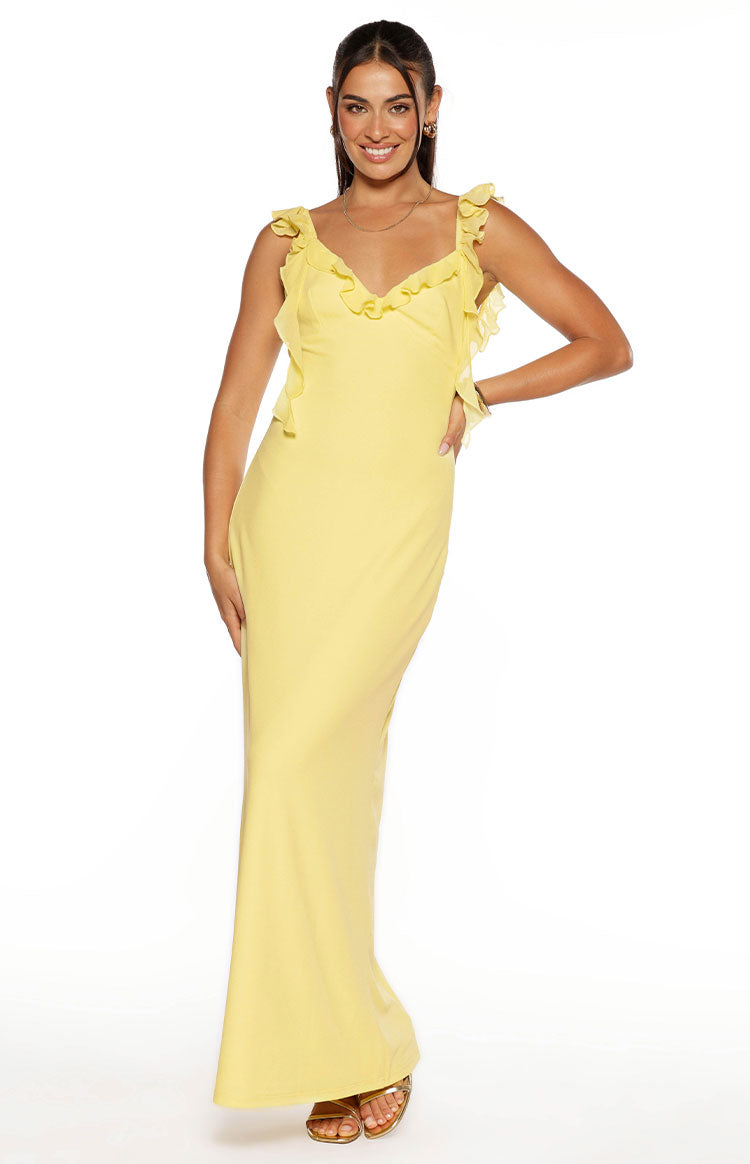 Front view of a yellow V-neck maxi dress with delicate ruffles on the straps and bodice