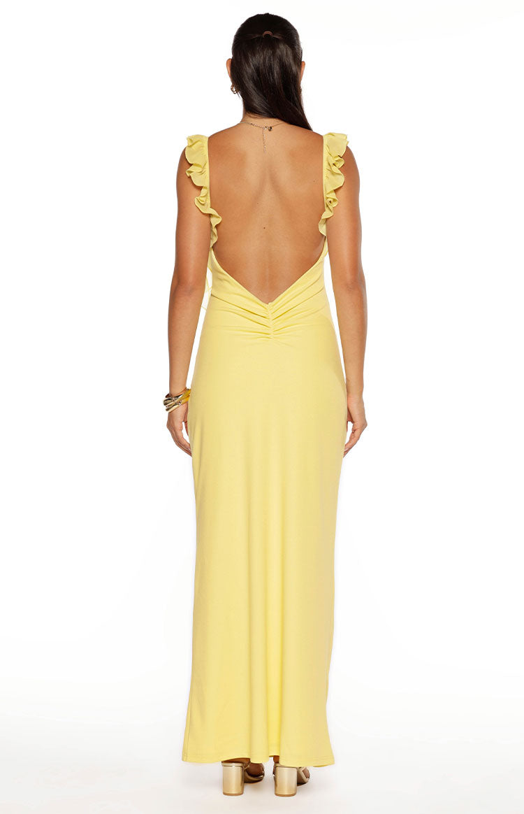 Rear view of a yellow formal maxi dress with ruffle straps and a low V-back with ruched detail