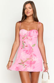 Sweetheart neckline with gathered bust detail on a pink mini dress with lily floral print