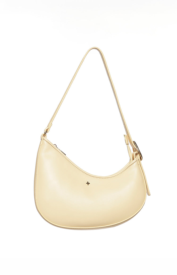 Angled view of a cinder yellow shoulder bag with a curved base and adjustable strap