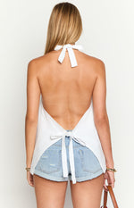 Back view of the white linen blend top showing the halter neck tie and adjustable back tie