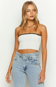 Close-up of the white ribbed knit tube top with black contrast binding at the strapless neckline