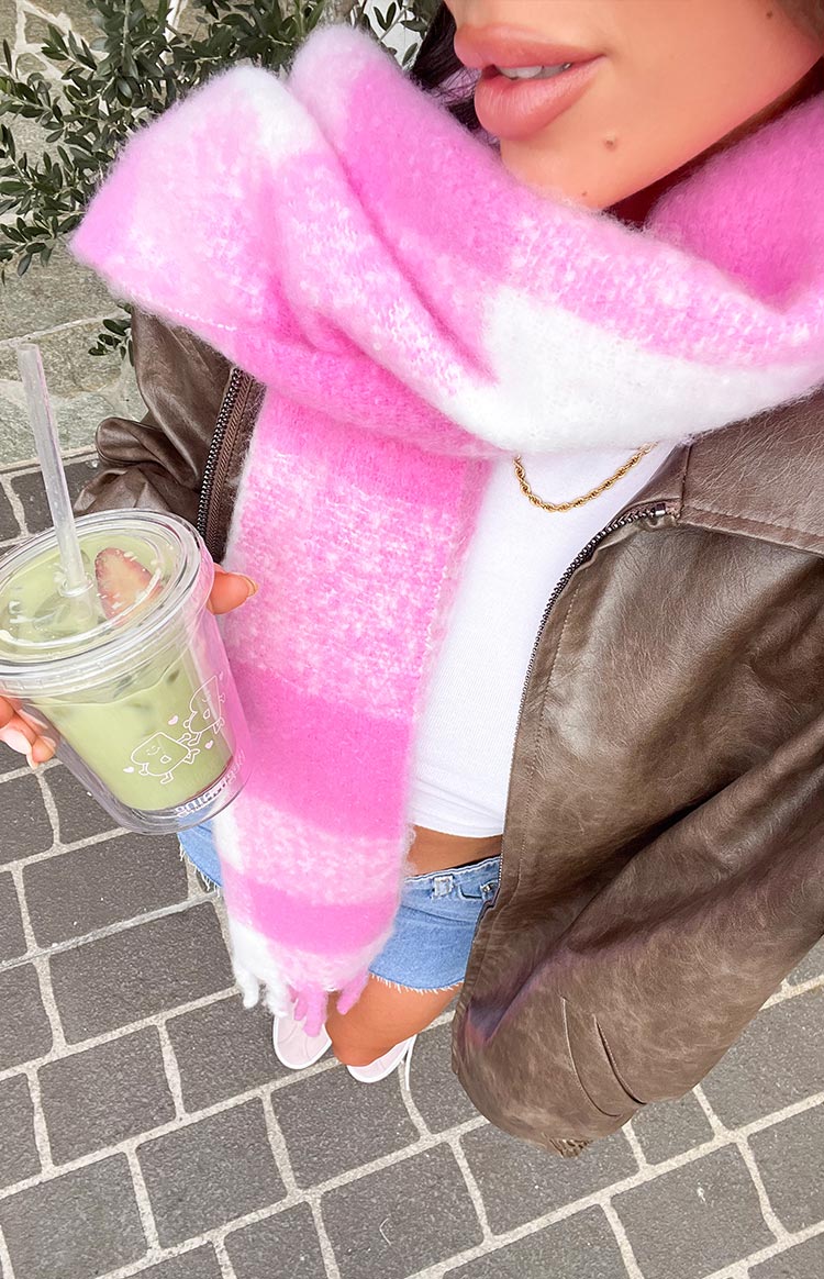 Close-up of the fluffy pink and white check blanket scarf with fringe