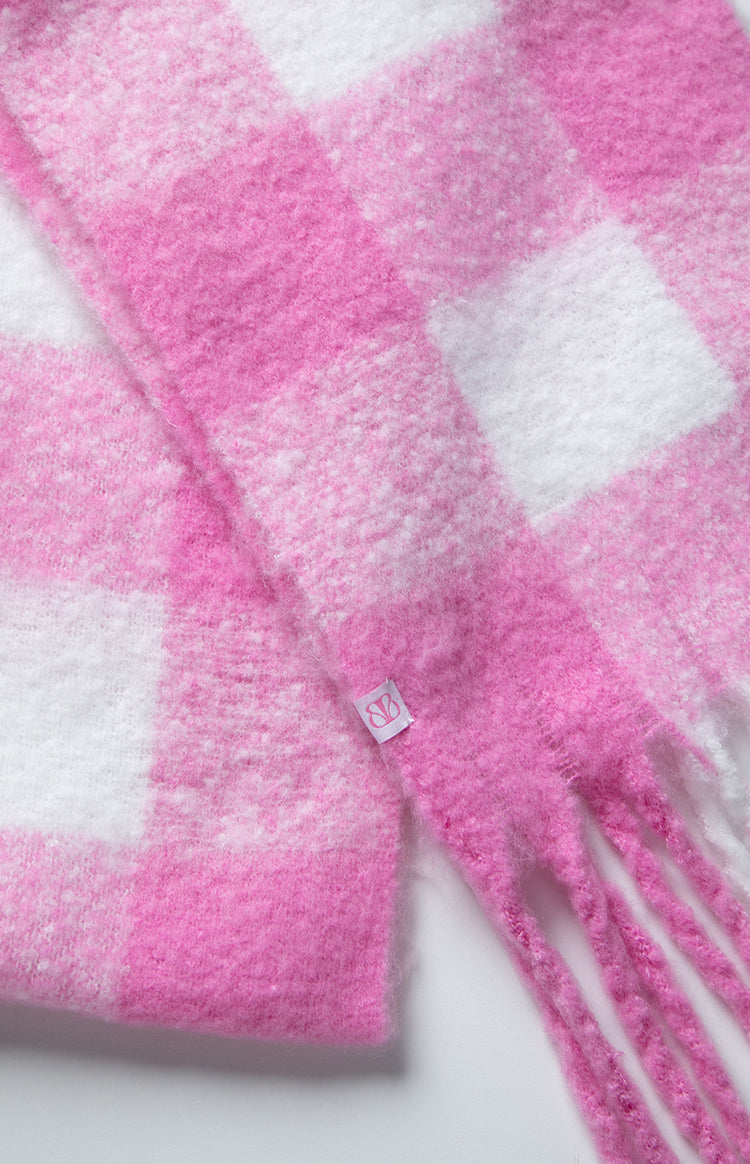 Close-up of the fuzzy pink and white check blanket scarf showing the fringed edge