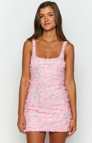 Front view of a pink mini dress with a square neckline and all-over pink sequins and 3D floral appliques