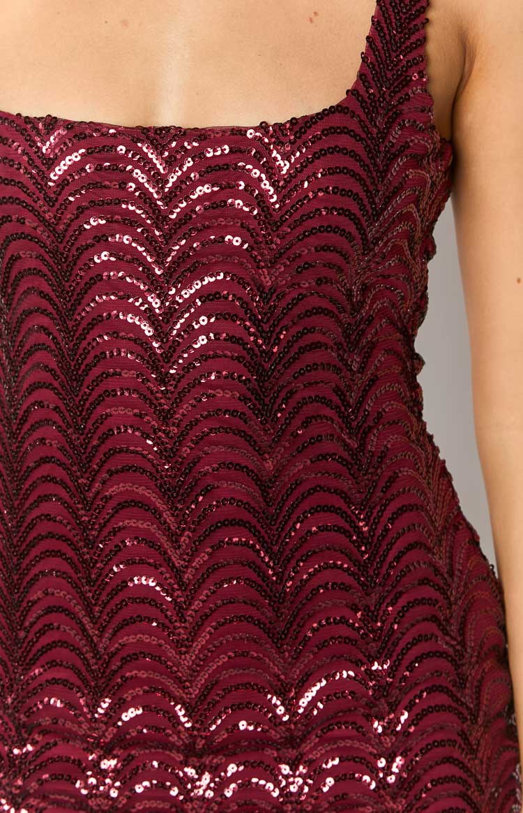 Close-up of the deep red sequin mini dress fabric with a shimmering chevron pattern of small round sequins