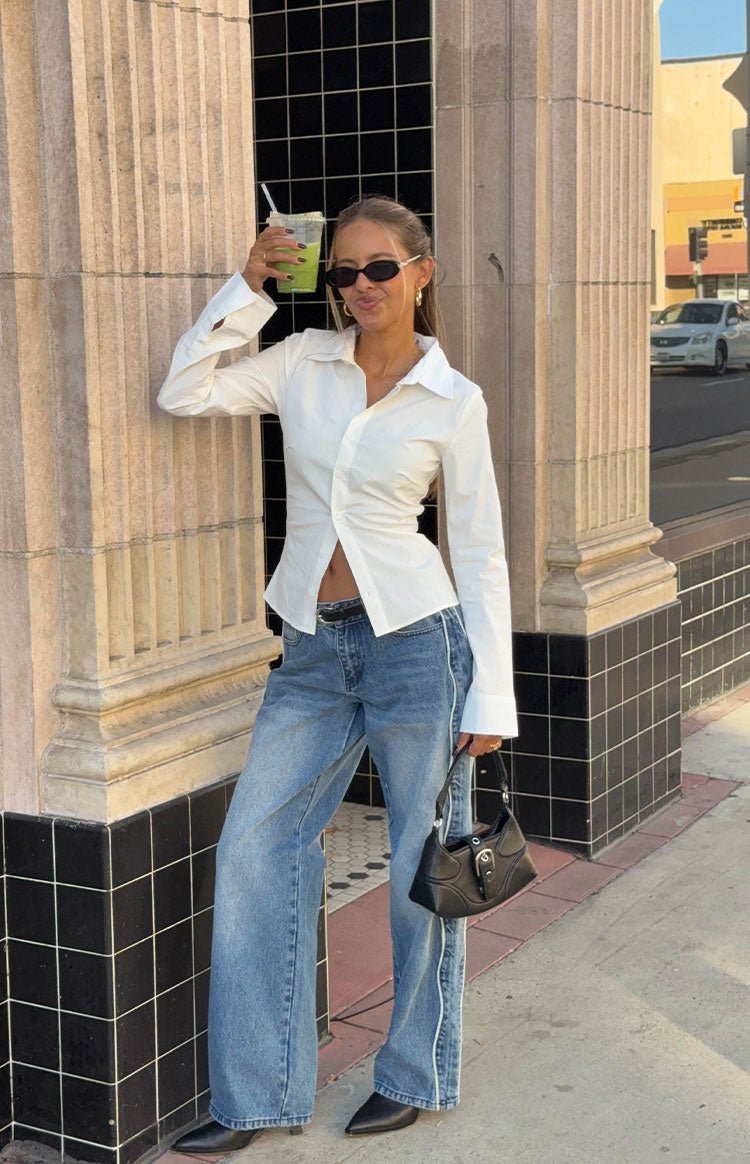 Full length mid wash wide leg jeans with white contrast seams down the outer legs