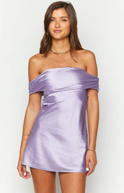 Purple satin mini dress featuring a draped off-the-shoulder neckline with ruched side details