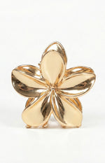 Front view of a polished gold metal flower claw clip with five curved petals