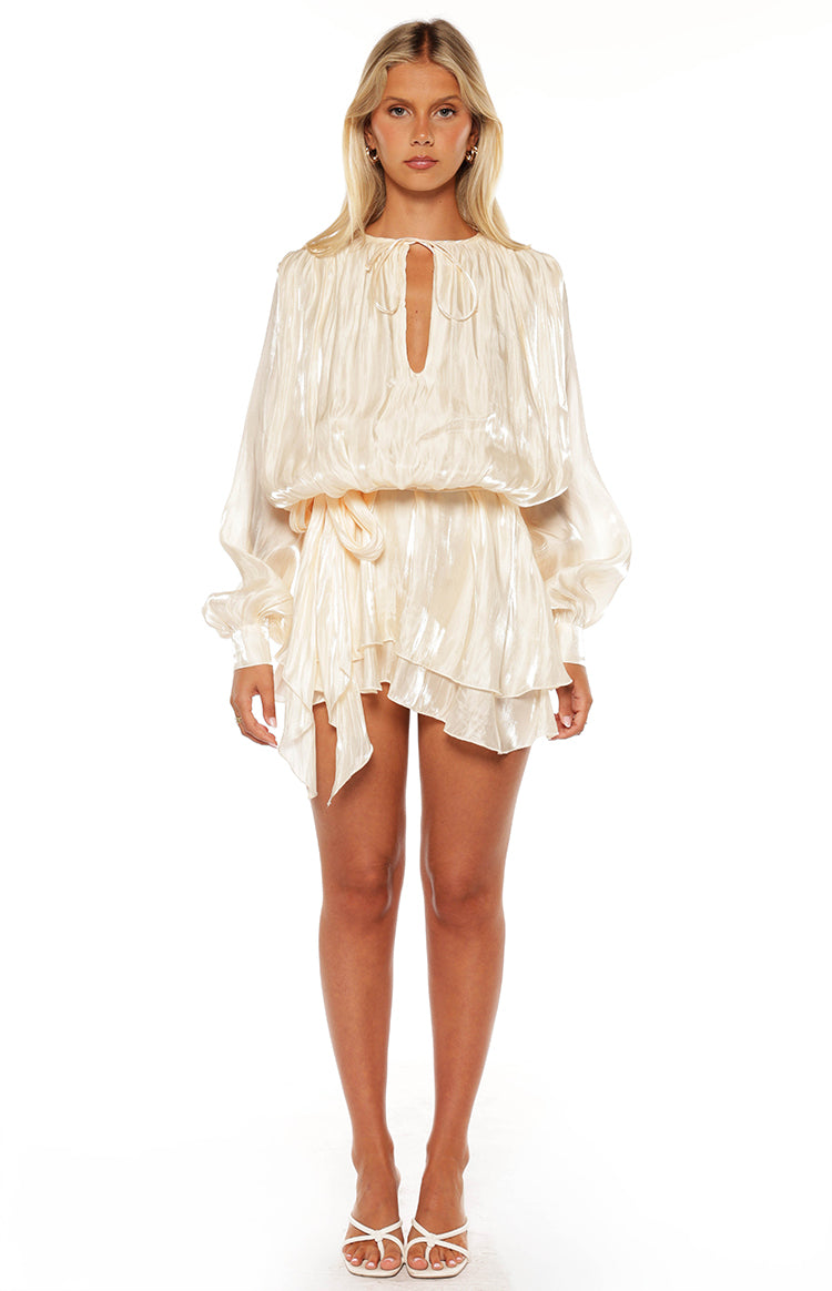 Pearl satin mini dress featuring a tie-neck, blouson long sleeves, elasticated waist, and ruffled asymmetrical hem