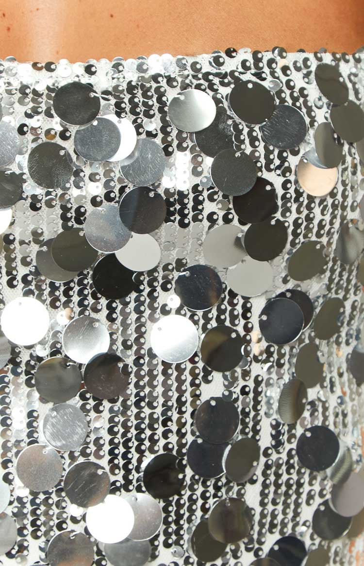 Close-up of the silver sequin fabric with small, tightly packed sequins and larger, round, dangling sequins