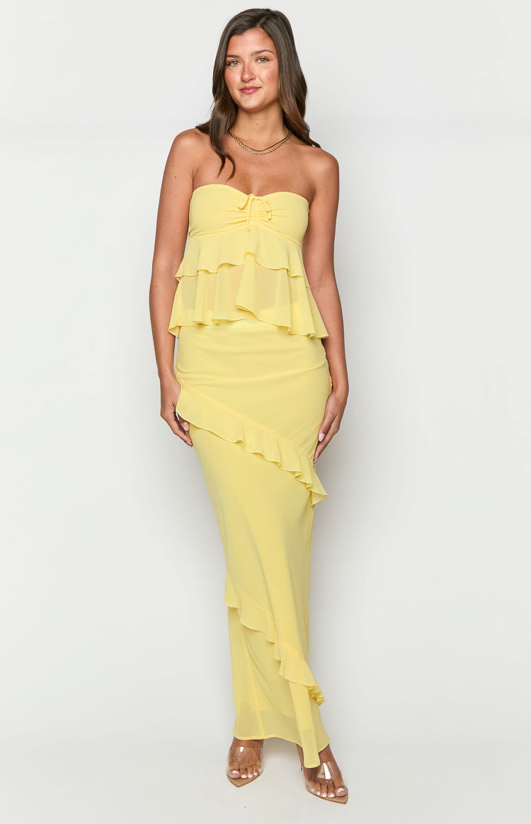 Yellow maxi skirt featuring a single diagonal ruffle from hip to hem