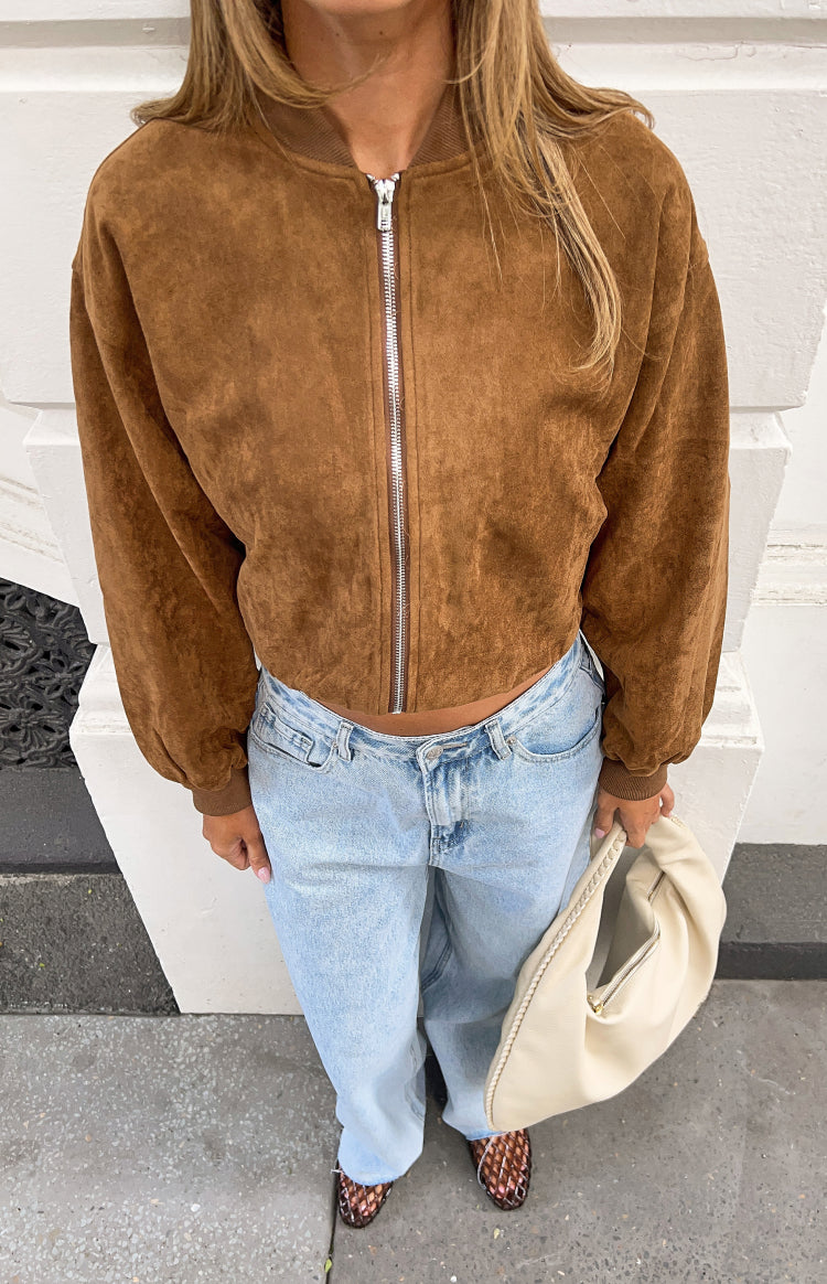 Top-down view of a cropped tan suedette bomber jacket with a full silver zip