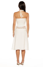 Rear view of a white midi skirt with a sheer lace detail band at the waist