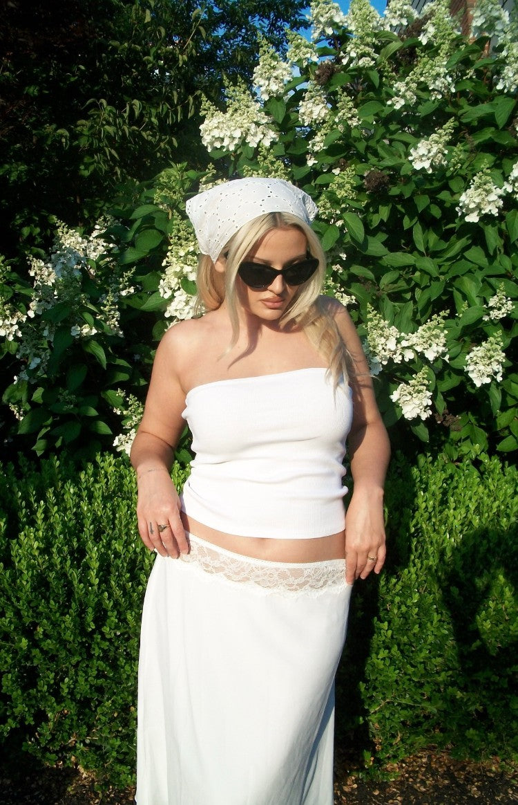 White midi skirt with delicate white lace trim visible at the low-rise waistline