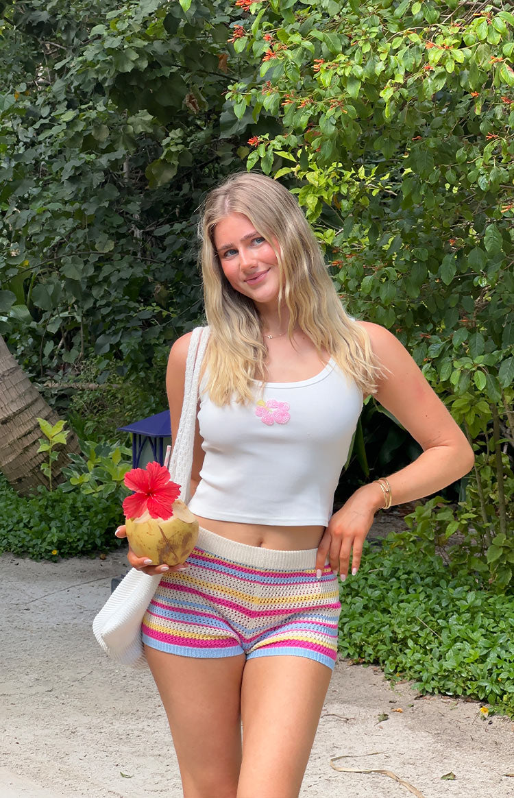 White ribbed tank top with a pink beaded hibiscus flower on the chest