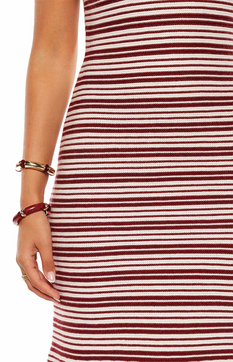 Close-up showing the fine knit texture of the burgundy and white striped maxi dress