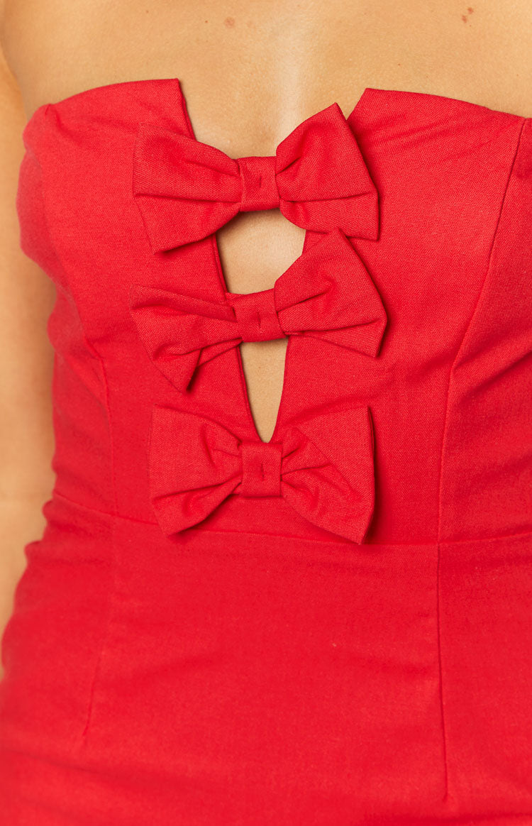 Close-up of the red dress bodice with three stacked bows and central keyhole cutouts