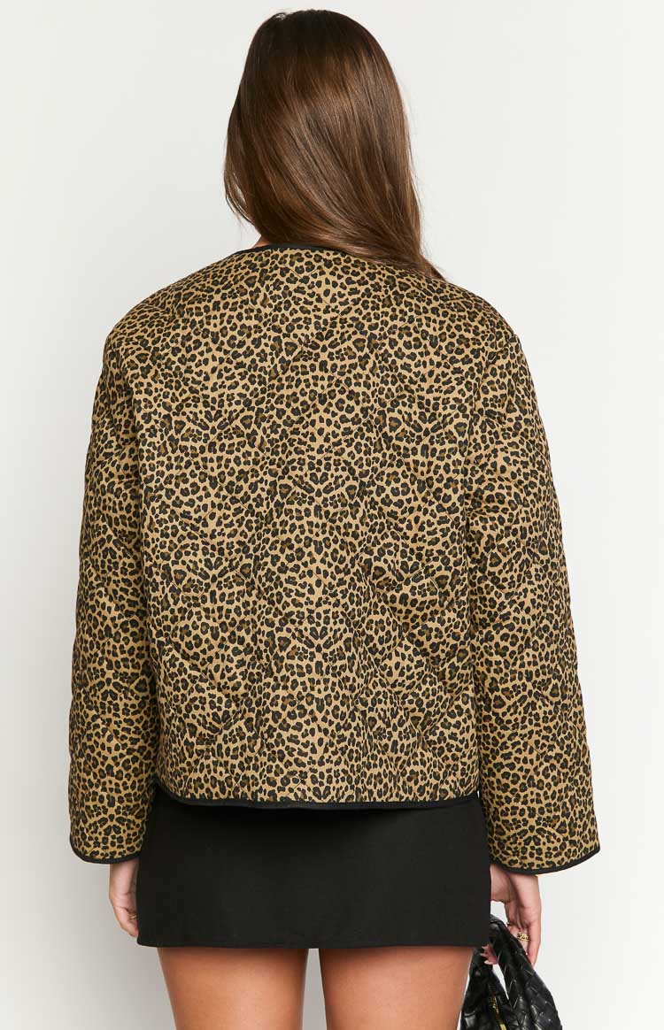 Rear view of a brown and black leopard print quilted jacket with a relaxed fit and black binding along the edges