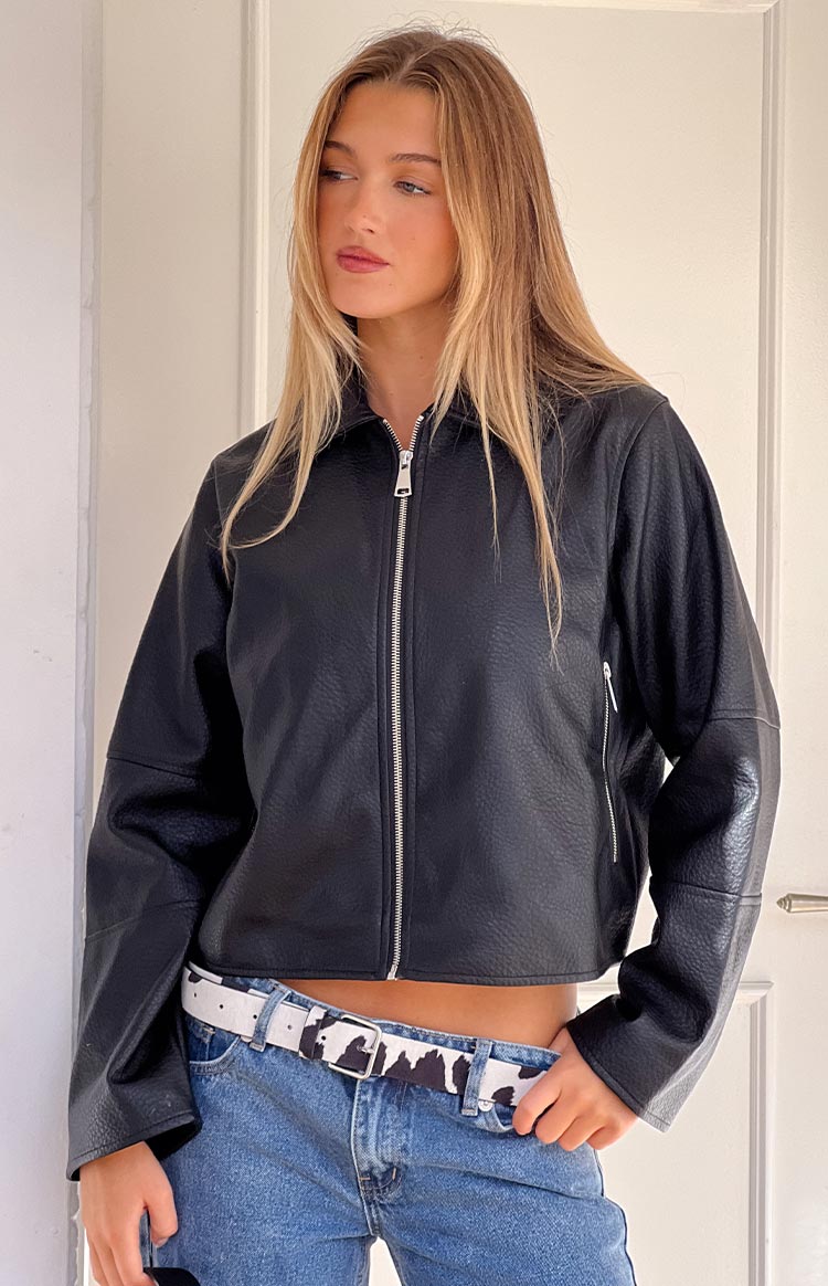 Front view of a black pebbled PU cropped jacket with a silver full-length zipper and side pocket zipper