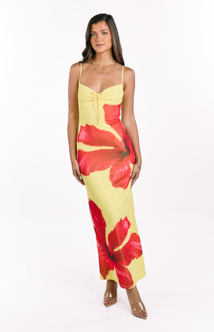 Yellow maxi dress with red hibiscus print, featuring a ruched bust with a central drawstring tie